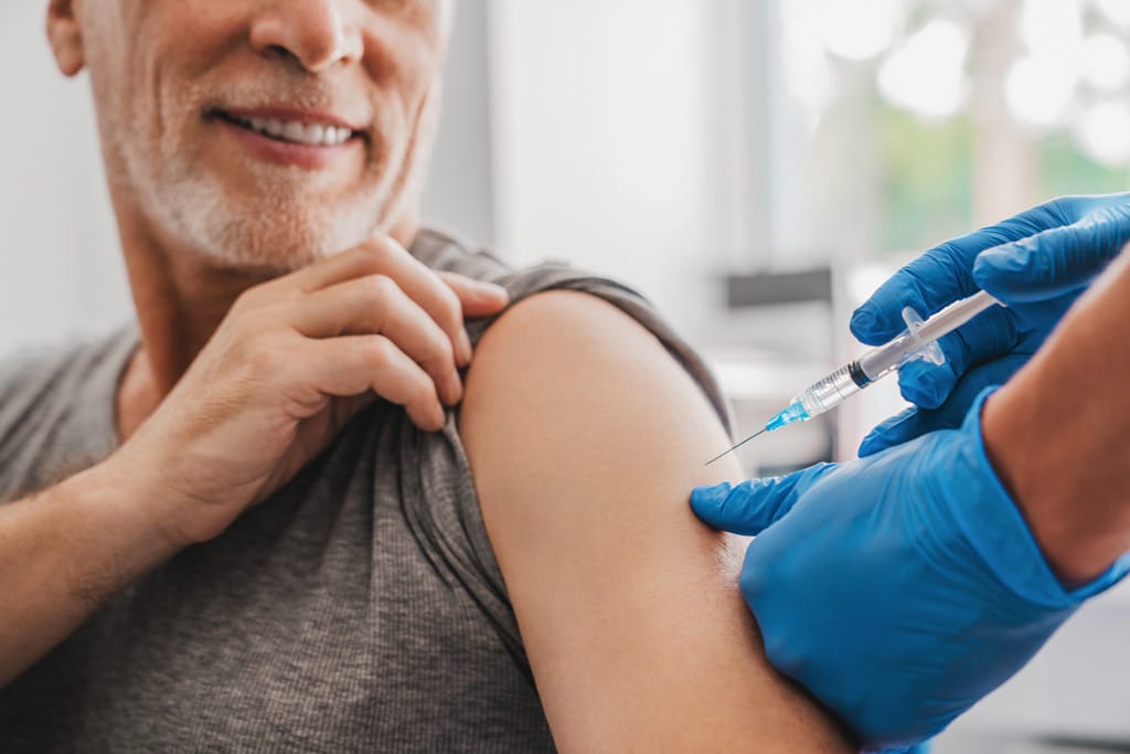 international medical clinic imc men's health with patient receiving vaccination